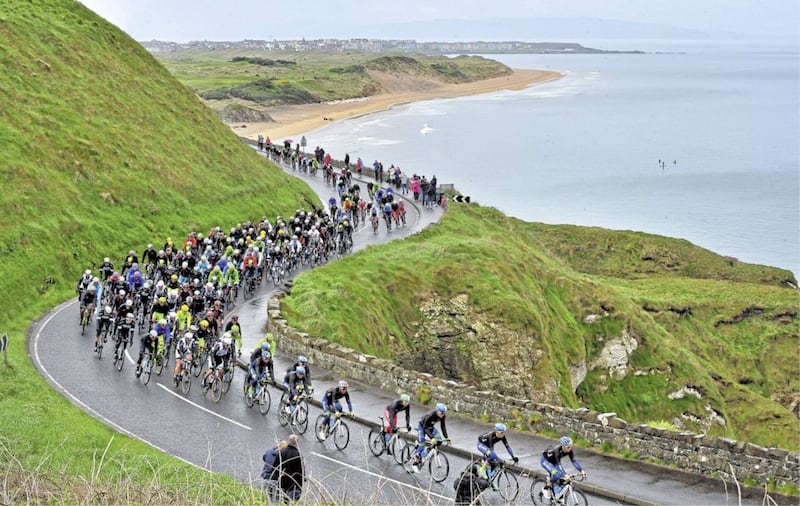 Giro d&#39;Italia cyclists on the Causeway Coast in May 2014 against the impressive backdrop of Whiterocks Beach, Portrush and Donegal mountains 
