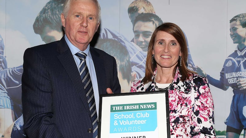 St Dallan's principal Una Farrell accepts last year's award from Irish News sports editor Thomas Hawkins&nbsp;