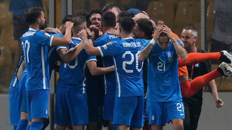Greece celebrate Giorgos Masouras’ decisive goal (Petros Giannakouris/AP)