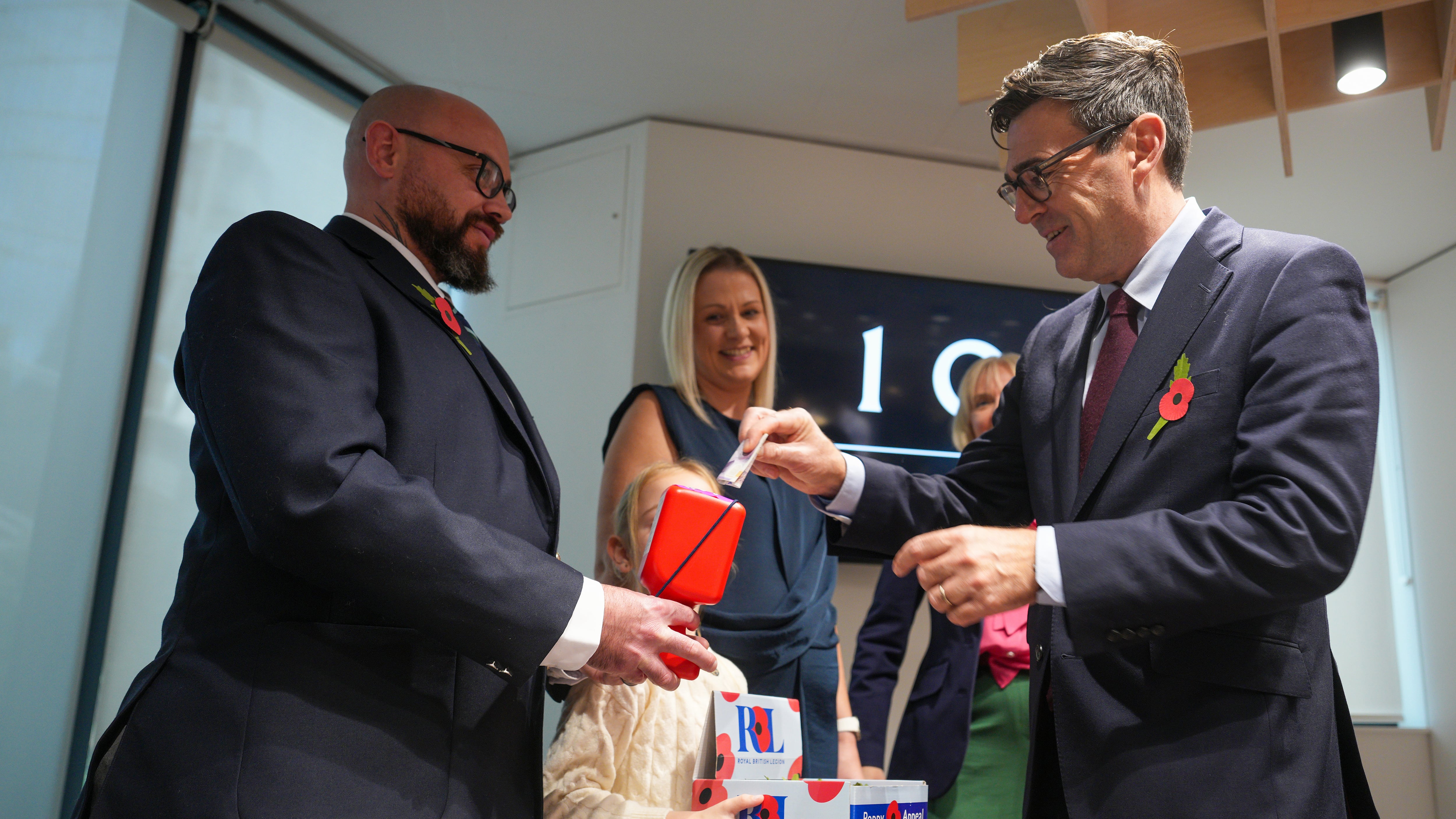 Prime Minister Andy Burnham speaks to British Army veteran Steven Knighton, at No 10 North in Manchester, as he donates and receives his poppy in support of this year’s Poppy Appeal