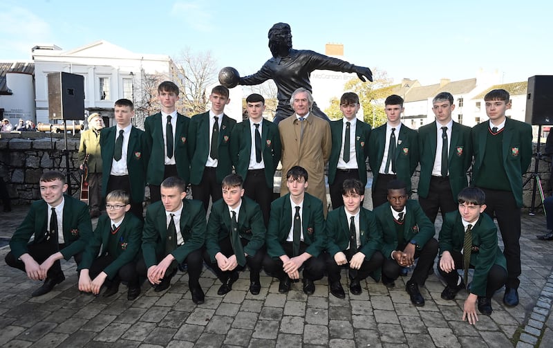 Former Tottenham and Northern Ireland goalkeeper Pat Jennings with boys from his former school St Josephs Boys School, Newry, at the unveiling of a statue in his honour in Newry town centre