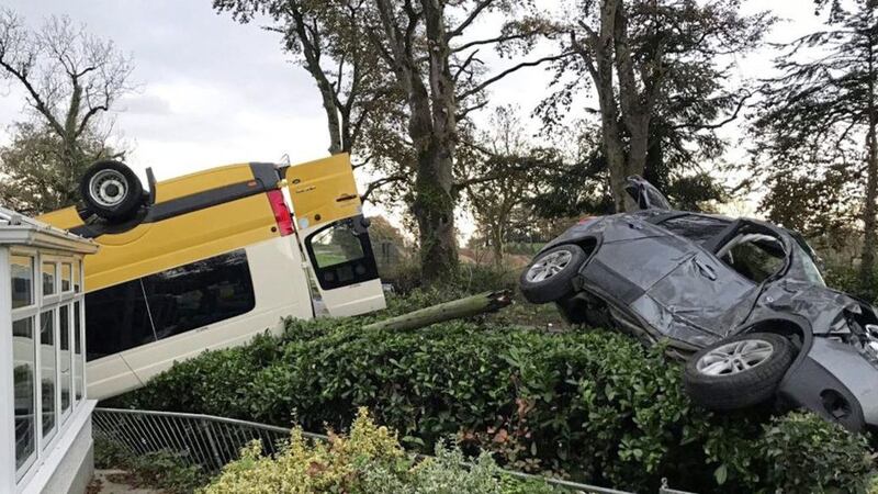 The minibus and car ended up in the garden of a house. Picture by BBC 