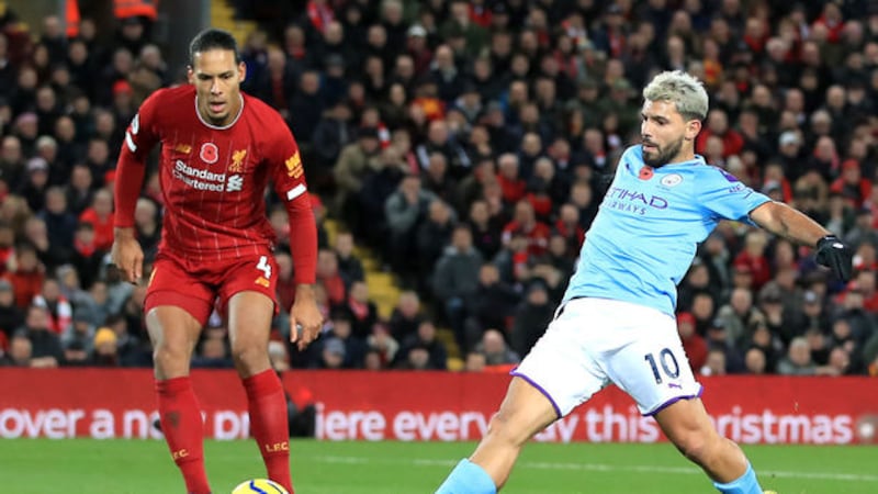 Liverpool's Virgil van Dijk pays close attention to Sergio Aguero of Manchester City.