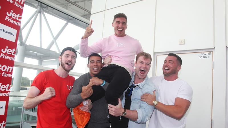 The rugby player was greeted by friends, family and fans waving banners at Shannon Airport.