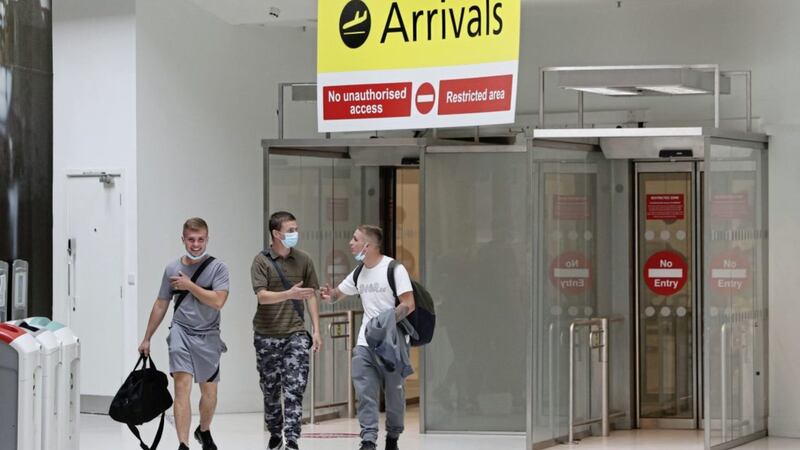 Passengers wearing facemasks after landing at Belfast City Airport. Picture by Brian Lawless/PA Wire. 