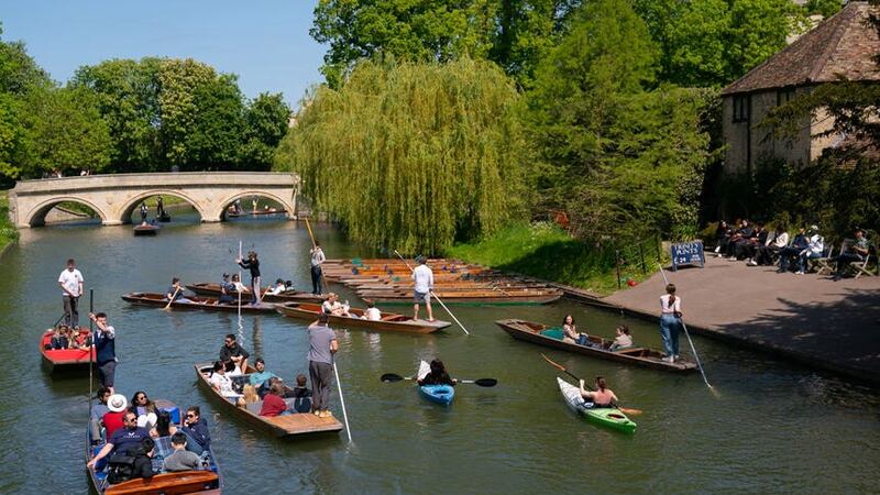 People enjoy the warm weather as they take punt tours along the River Cam in Cambridge (Joe Giddens/PA)