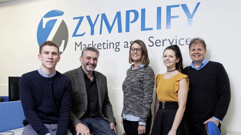 Dr Peter Bolan of Ulster University at the official opening of Zymplify&rsquo;s new offices located in Portstewart. He is pictured with &lsquo;ZympliGuru&rsquo; team members Michael Lynch, Carly Warke, Rebecca Millar and Michael Carlin (chief executive) 