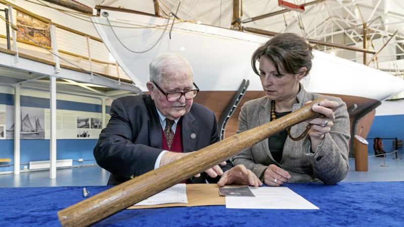 Colm Galligan and National Museum Director Lynn Scarff with the Asgard Baton. The Asgard gun-running ship is pictured in the background. Picture by Paul Sherwood 