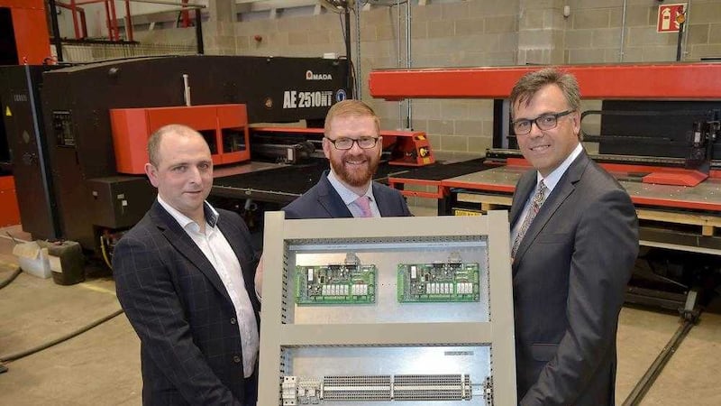 Economy minister Simon Hamilton, centre, with Alastair Hamilton, right, chief executive of Invest NI and Colum Hadden, managing director of Critical Power Systems   