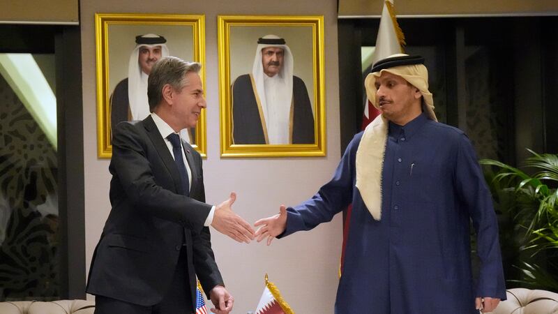 US Secretary of State Antony Blinken, left, shakes hands with Qatar’s Prime Minister and Foreign Affairs Minister Mohammed Bin Abdulrahman Al Thani, at Diwan Annex, in Doha, Qatar, on Tuesday (Mark Schiefelbein/AP)