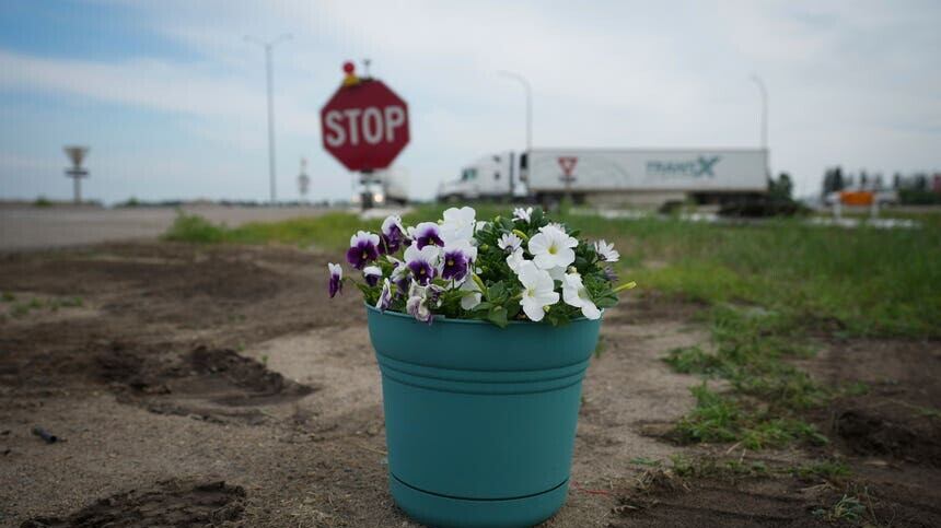 A pot of flowers marks the place where the crash happened (The Canadian Press via AP)