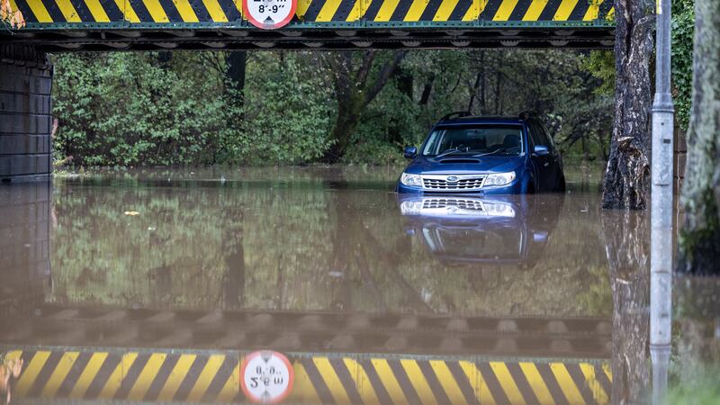 A car left abandoned under a flooded railway bridge in Dumbarton on Saturday (Robert Perry/PA)