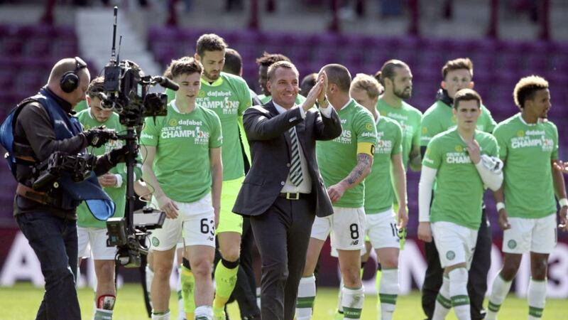 Celtic manager Brendan Rodgers applauds the fans after his teams sealed their Ladbrokes Premiership title with a 5-0 win over Hearts at Tynecastle yesterday Picture: PA 