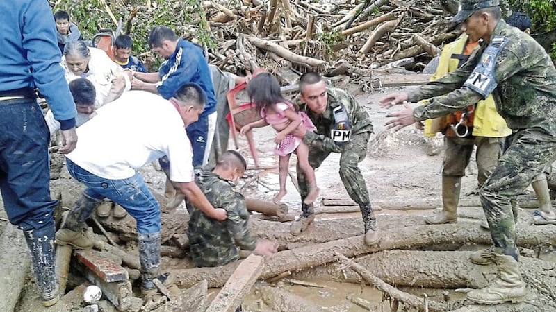 Soldiers rescue a child in Mocoa, Colombia, Saturday, April 1 PICTURE: Colombian Army Photo via AP 
