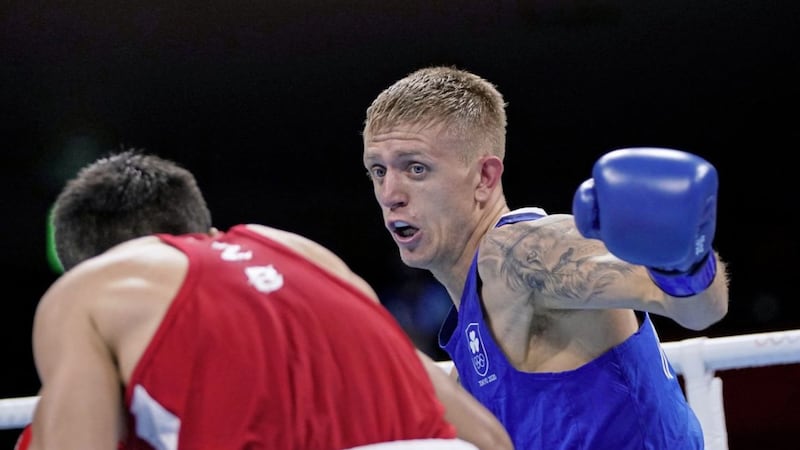 Ireland&#39;s Kurt Anthony Walker competes with Uzbekistan&#39;s Mirazizbek Mirzakhalilov during the men&#39;s featherweight 57-kg boxing match at the 2020 Summer Olympics, Wednesday, July 28, 2021, in Tokyo, Japan. (AP Photo/Frank Franklin II, Pool). 