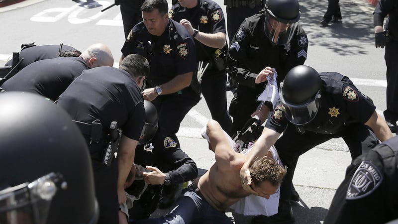 Police take a protester into custody (AP Photo)&nbsp;