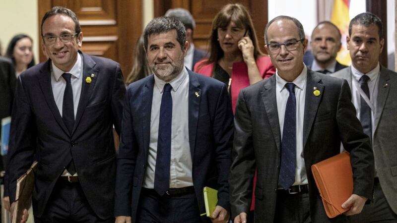 Catalan politicians Josep Rull, Jordi Sanchez and Jordi Turull leave after collecting their credentials at the Spanish parliament in Madrid Picture by Bernat Armangue/AP 