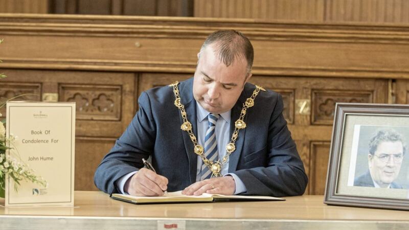 Derry City and Strabane District Council Mayor, Councillor Brian Tierney signs the Book of Condolence in the City&#39;s Guildhall for Noble Laureate John Hume. 