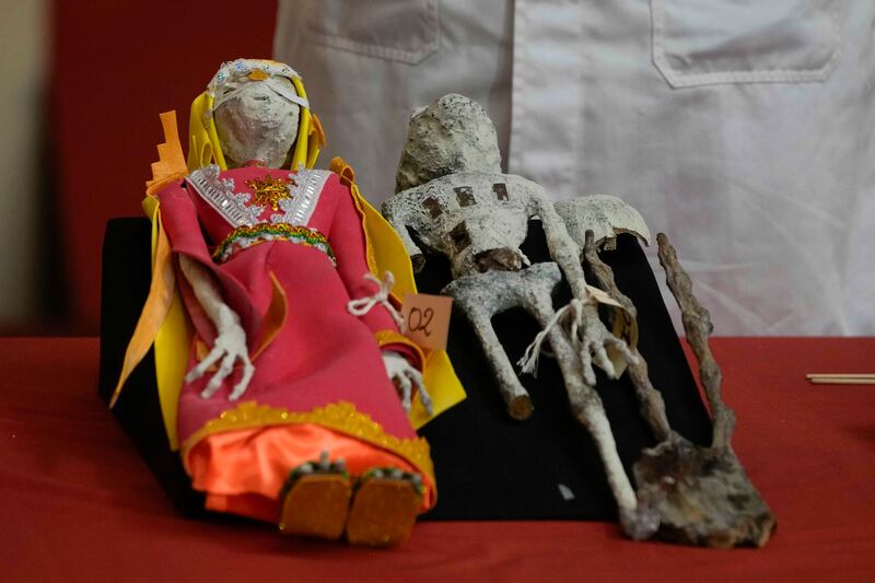 Dolls that were seized by authorities are displayed during a press conference to explain what they are made of at the Archaeology Museum in Lima, Peru (Martin Mejia/AP)