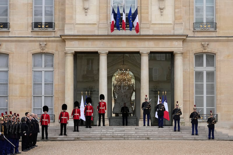 British and French soldiers stand guard at the Elysee Palace on Monday (Thibault Camus/AP)