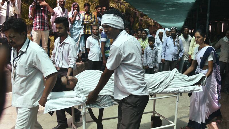 A person injured in a fire at Pulgaon ammunitions depot is brought in for treatment at a hospital in Wardha, India. Picture by Associated Press&nbsp;