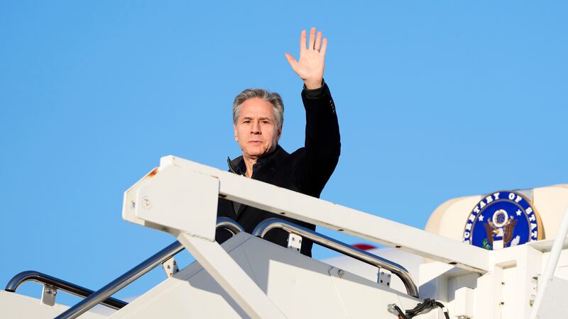 US Secretary of State Antony Blinken waves as he boards a plane on Sunday, en route to Saudi Arabia (Mark Schiefelbein/Pool/AP)