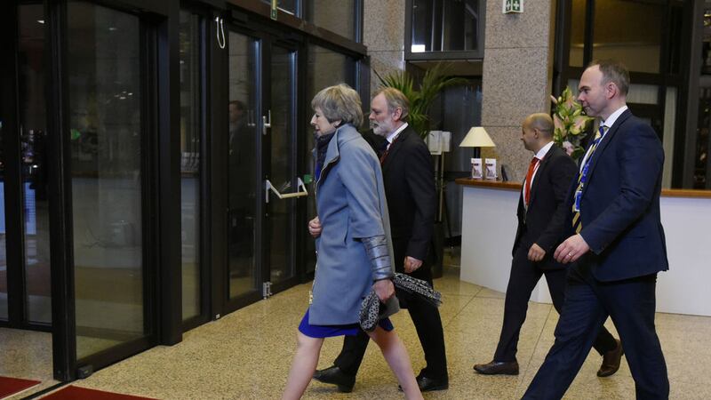 Theresa May, left, leaves with her delegation at the conclusion of an EU summit in Brussels, Thursday, April 11, 2019&nbsp;