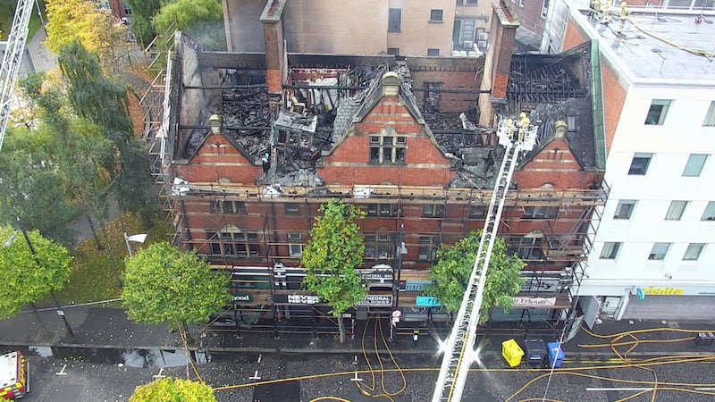 Handout photo issued by Northern Ireland Fire and Rescue Service of firefighters at the scene of a blaze at a historic building in Belfast's Cathedral Quarter, where more than 50 personnel have been involved in the operation at Old Cathedral Building on Donegall Street s