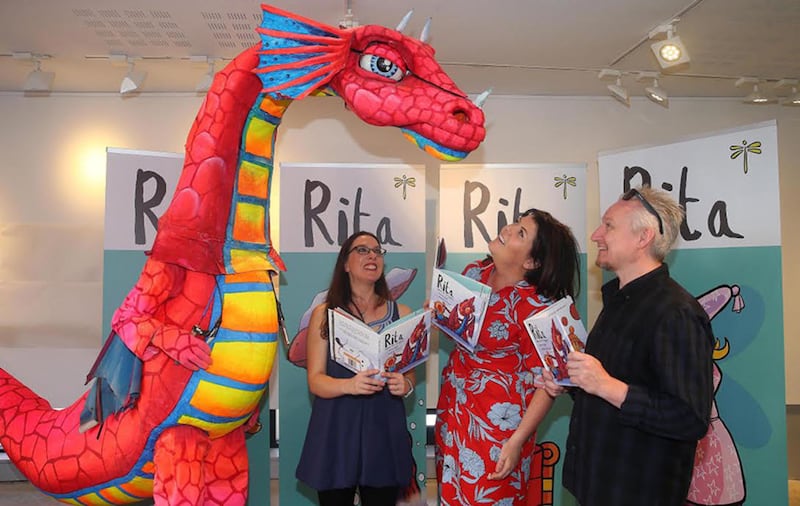 Lynette Faye helps launch Rita agus and Dragun with Maire Zepf author and Illustrator Andrew Whitson. Picture by Mal McCann&nbsp;