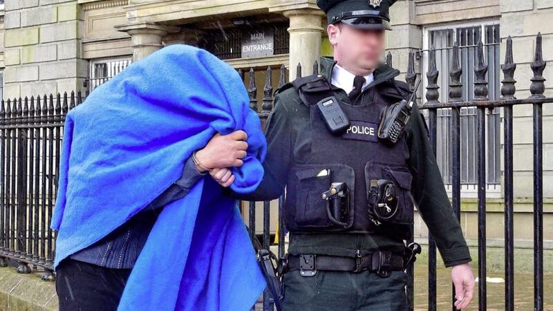 James Wright arrives at court with a blanket covering his head during a hearing in 2016 when he was charged with rape. Picture by Mark Winter / Pacemaker Press. 