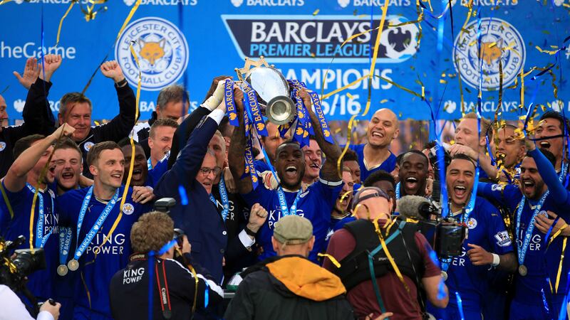 Leicester City captain Wes Morgan and manager Claudio Ranieri lift the trophy as the team celebrate winning the Barclays Premier League&nbsp;