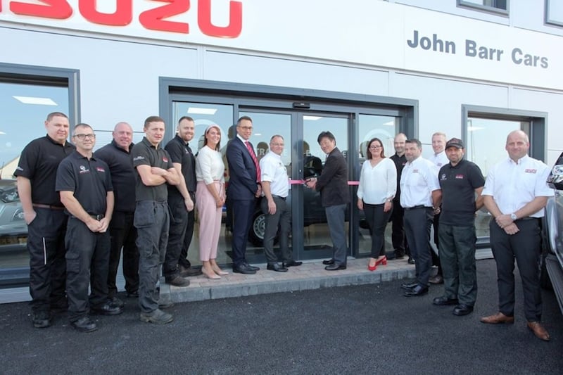 John Barr Cars Isuzu in Antrim was opened by Isuzu Europe MD and CEO Mikio Tsukui and Isuzu UK MD William Brown. They are pictured with John and Claire Barr and their team