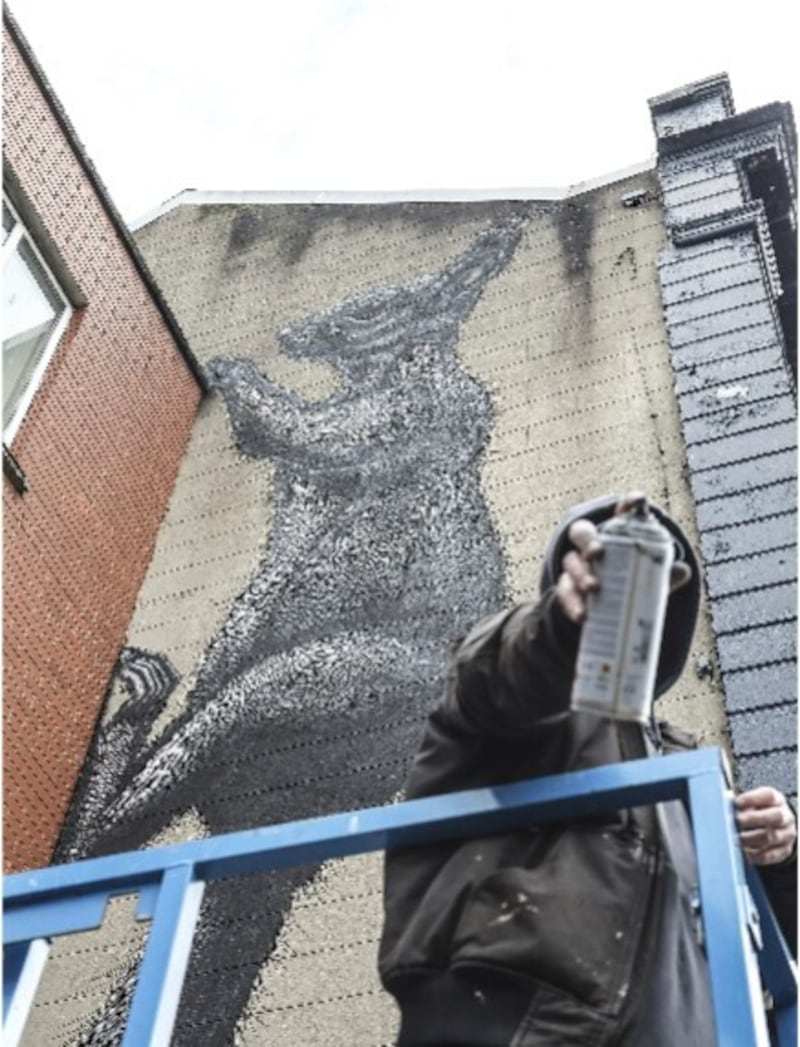 Belgian's R.O.A creating the huge Donegall Street squirrel. Picture by Hugh Russell