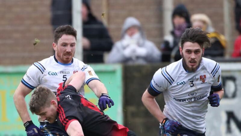 Down's Conor Maginn is tackled by UU's Malachy Magee and Conor Burke Picture by Cliff Donaldson