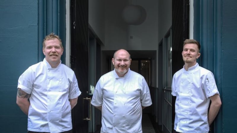 Niall McKenna (centre) outside his new Waterman restaurant with Cathal Duncan (left), Waterman House Cookery School chef, and Aaron McNeice (right), new head chef at Waterman.