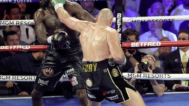 Deontay Wilder (left) and Tyson Fury during their WBC heavyweight title clash in February. Fury has vowed to emerge as a &quot;different person&quot; from the coronavirus crisis  