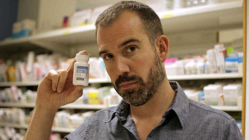  Dr Xand van Tulleken holding a bottle of anabolic steroids. Picture by Annie Mackinder (BBC) 