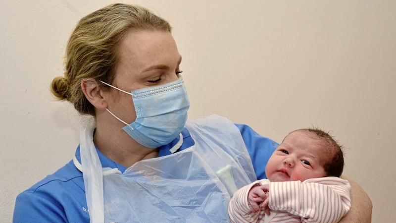Stacy Rooney from Lisburn gave birth to a baby girl at 03.04 on Christmas morning, pictured herre with midwife Grainne Holland at the Royal Victoria Hospital. Picture by Arthur Allison/Pacemaker Press 