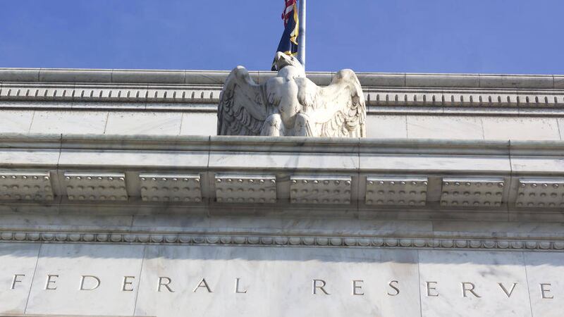 Federal Reserve building in Washington DC, US. Close up of a top part of the building with eagle statue. 