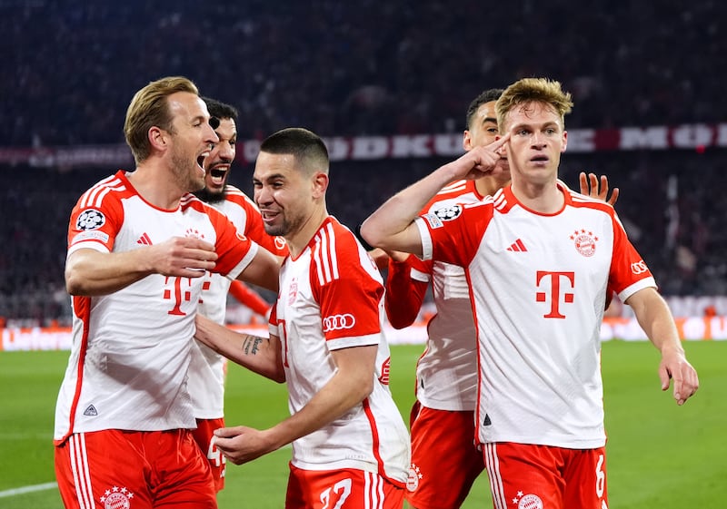 Bayern Munich’s Joshua Kimmich, right, celebrates with team-mates after scoring the winning goal for Bayern Munich