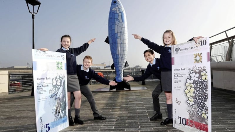 Katie-Jane McKibbin, William McMurtry, Rhys Barr and Asha Phillips, pupils at Glenwood PS in Belfast, help get ready for the introduction of Ulster Bank&#39;s new vertically-oriented bank notes at Donegall Quay by helping turn the &#39;Big Fish&#39; vertical. Photo: William Cherry/Presseye 
