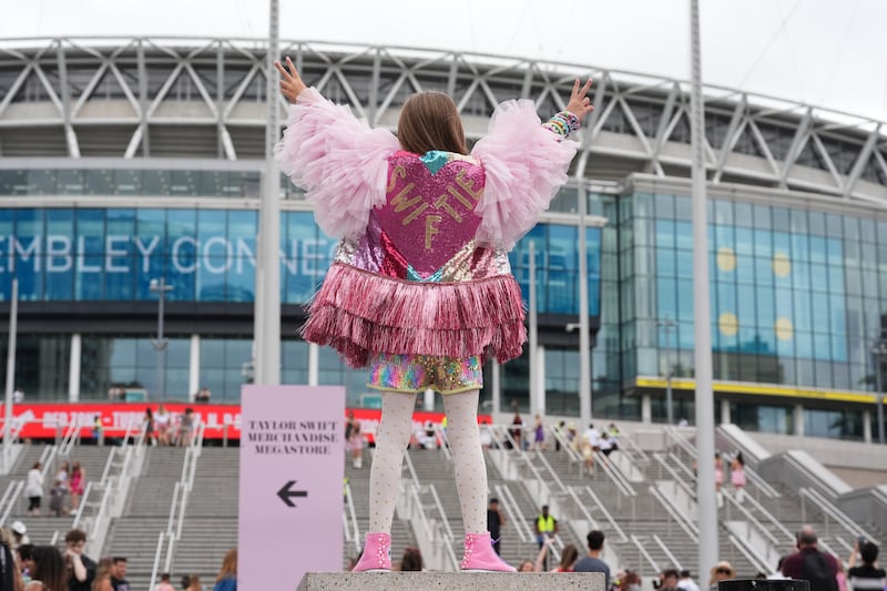 A young fan poses outside Wembley Stadium ahead of a concert