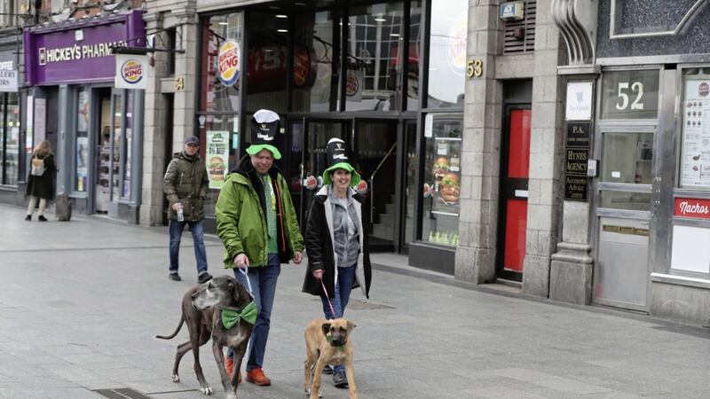 Tourists walk along a near empty O&#39;Connell Street in Dublin on St Patrick&#39;s day. Picture by Niall Carson, Press Association              