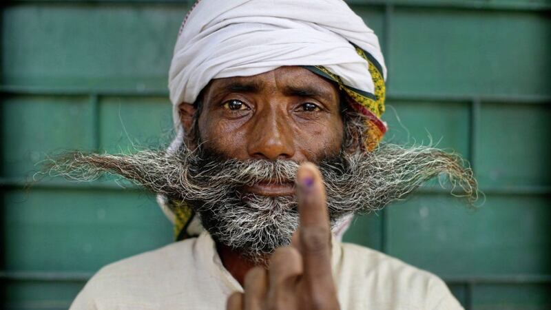 An Indian displays indelible ink mark on his index finger after casting his vote. Picture by Rajesh Kumar Singh/PA 