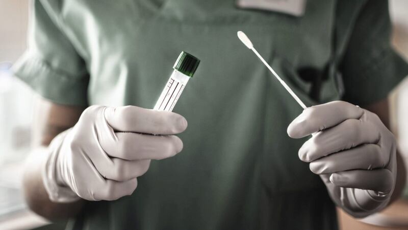 A nurse holds a swab for the Covid-19 test 