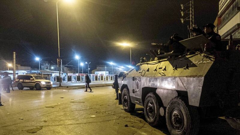 A riot policemen stand next to an APC during anti-government protests in Tunis, Tunisia PICTURE: Amine Landoulsi/AP 