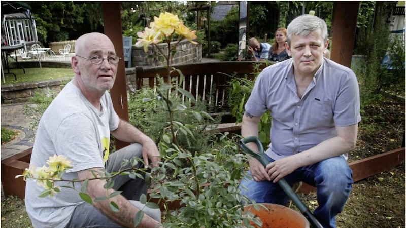 Thomas and Jim McConville plant a rose bush in memory of their brother Billy. Picture by Hugh Russell 