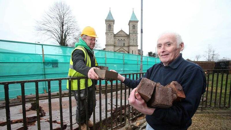 Resident Paddy Copeland collects some souvenir bricks from the peace wall in Ardoyne. Picture by Mal McCann 