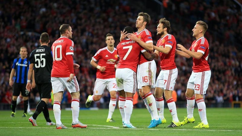 Manchester United&#39;s Memphis Depay (no.7) celebrates scoring his side&#39;s first goal of the game with teammates during their Champions League first-round play-off against Brugge 