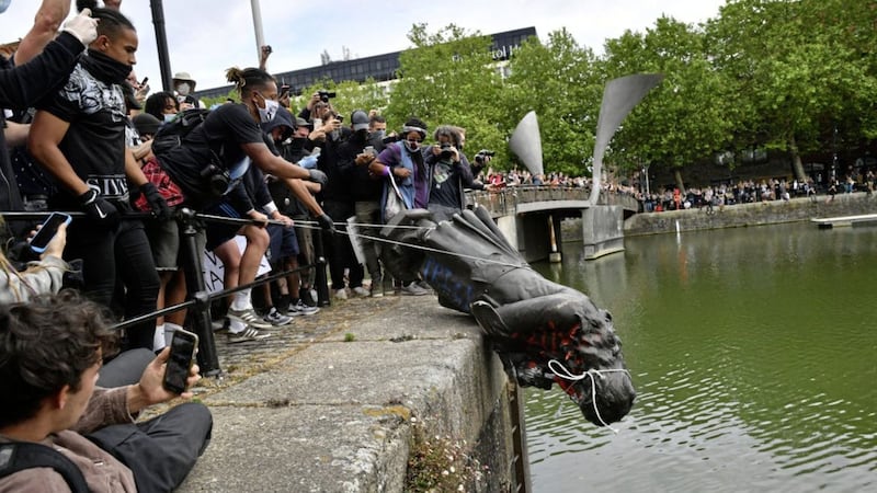 A statue of Edward Colston is thrown into Bristol harbour during a Black Lives Matter protest rally in memory of the late George Floyd last weekend. Picture by Ben Birchall/PA 